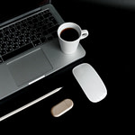cup of coffee on top of a laptop computer