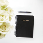 black spiral book on white surface