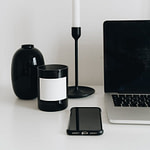 laptop and smartphone with set of white and black items