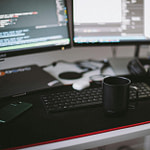 black ceramic mug in front of a computer