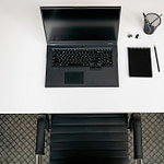 top view of a contemporary neat desk with a laptop notepad and writing supplies