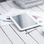 white tablet and cup of coffee