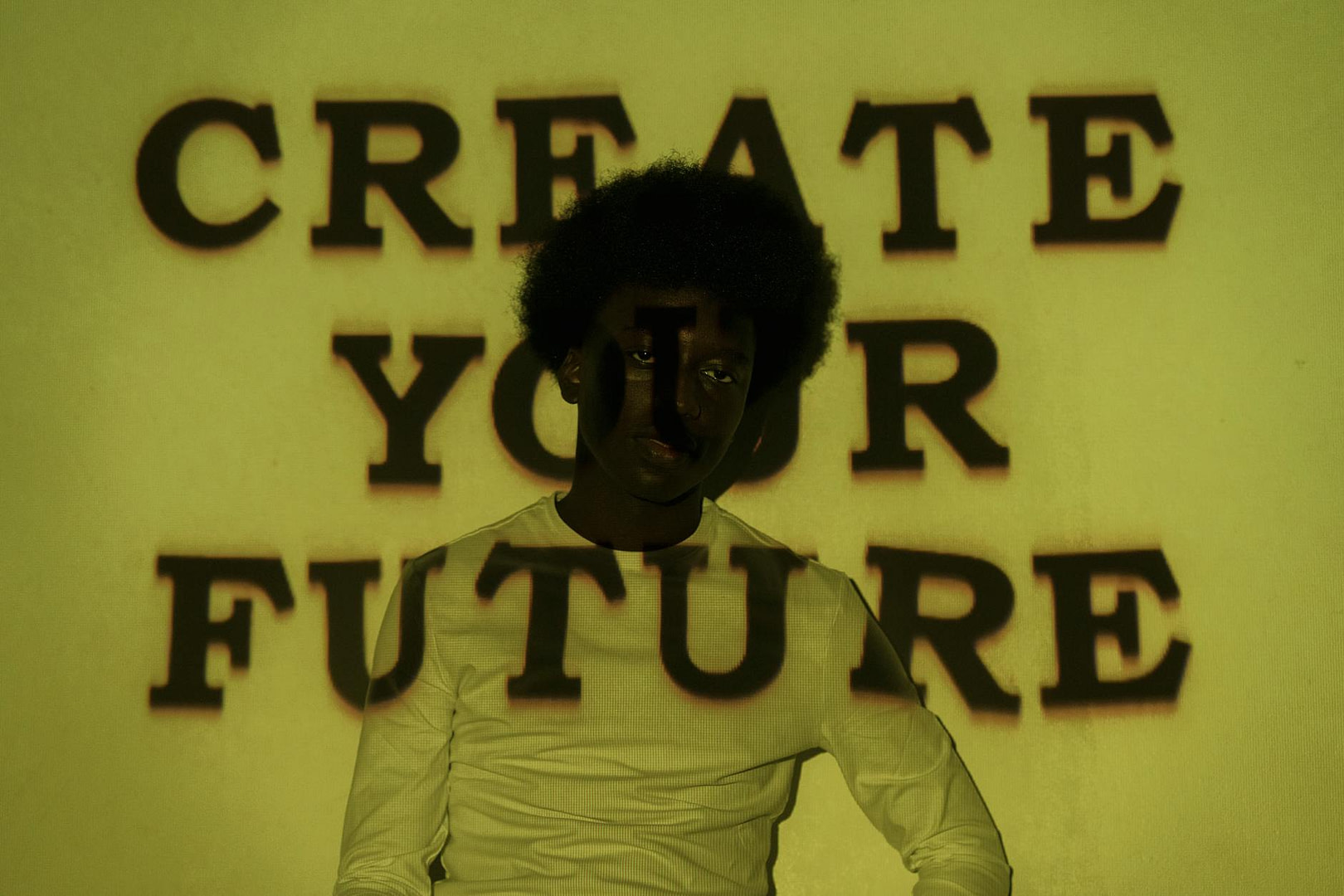 man in white long sleeve shirt with yellow background