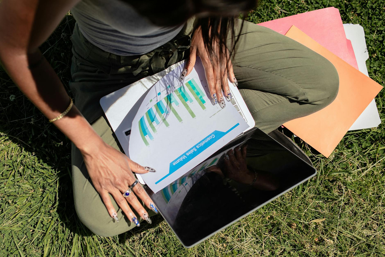 woman with long nails looking at documents