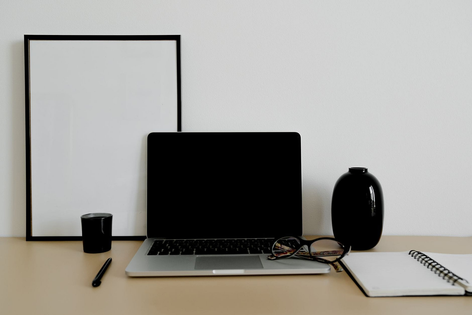 laptop and notebook on a desk