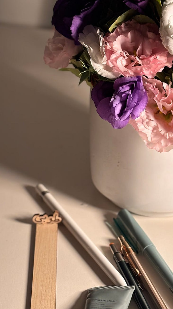 elegant floral arrangement with stationery on desk