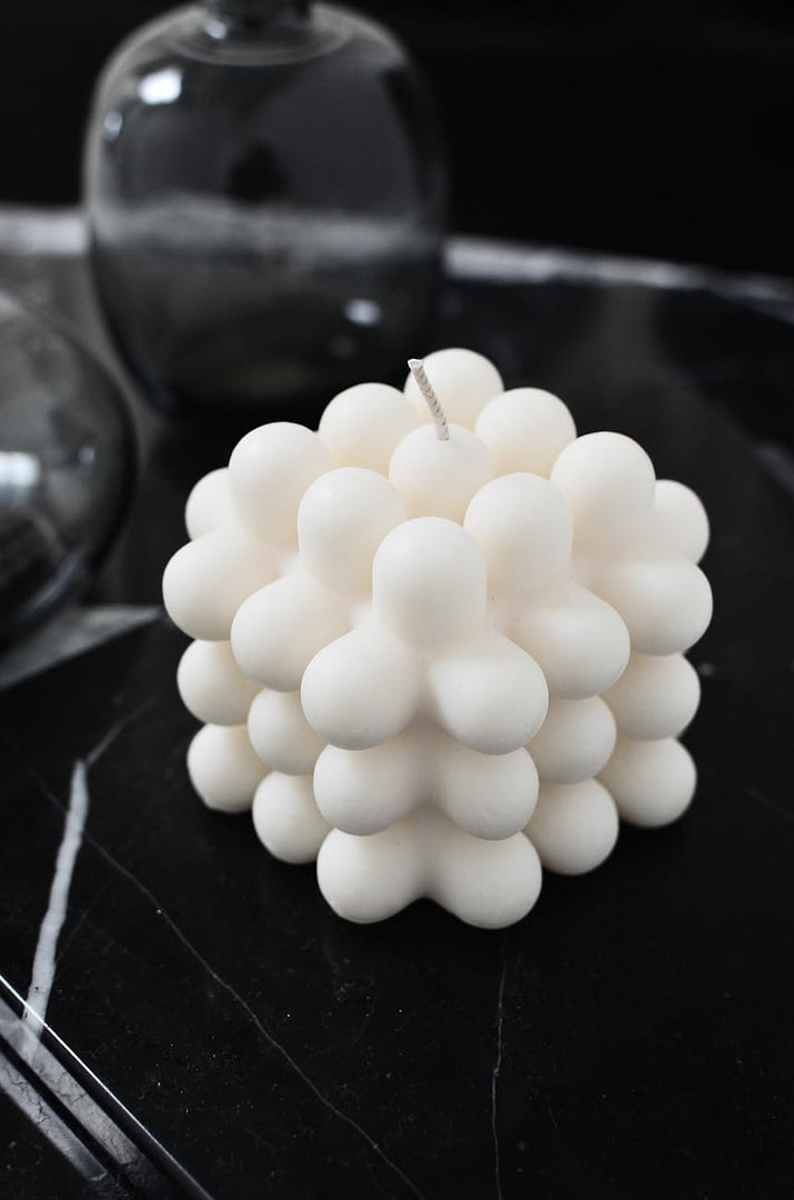 creative white candle on table in living room