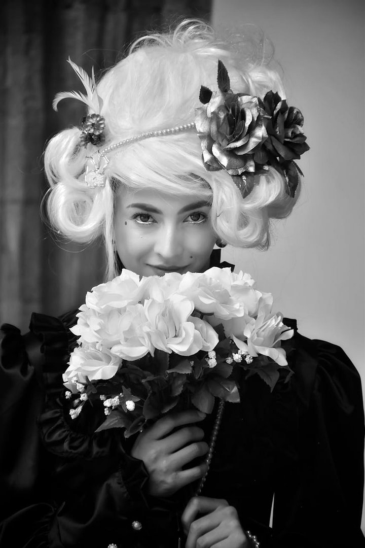 woman in baroque dress holding bouquet